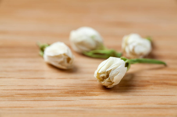 Gedroogde jasmijn bloemen thee op houten tafel. - Foto, afbeelding