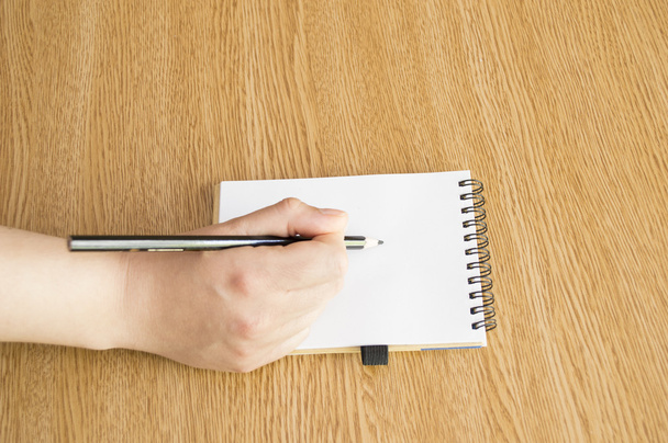 hand with pen writing down notes - Photo, image