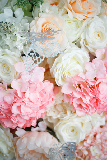 Pink hydrangeas, white and tea roses. On flowers sit silvery butterflies - Valokuva, kuva