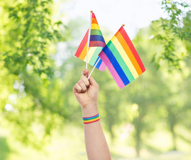 hand with gay pride rainbow flags and wristband - Photo, Image