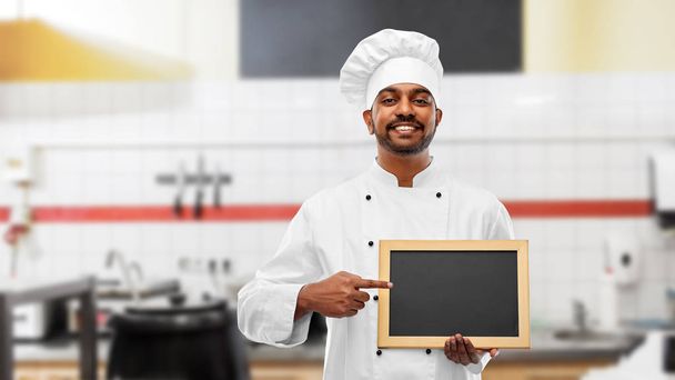 indian chef with chalkboard at restaurant kitchen - Фото, зображення