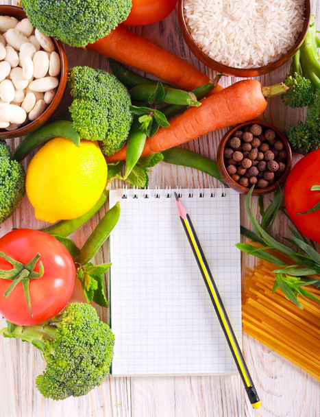 Fresh food ingredients and notepad  - Foto, afbeelding