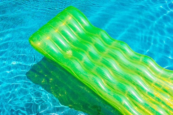 Colorful swim ring or rubber float around swimming pool water - Photo, Image