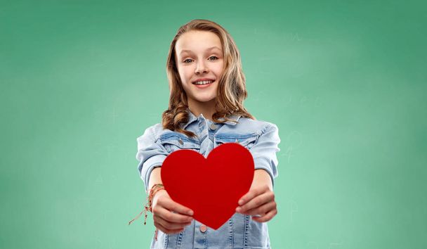 girl with red heart over green school chalk board - Photo, Image