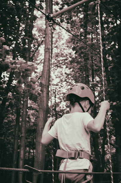 The boy climbs a pendant park - Photo, Image