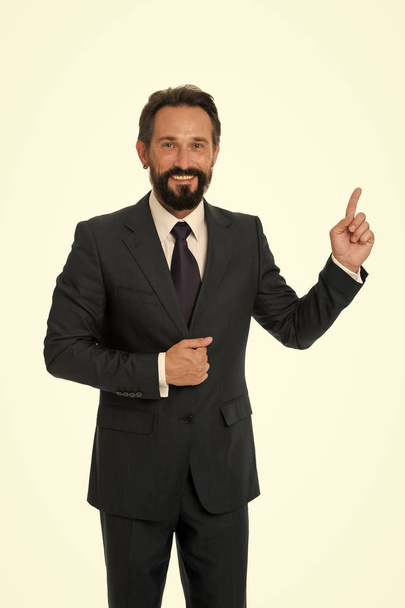 Pointing at business advertisement. Man pointing index finger advertisement isolated on white. Man bearded mature formal suit. Businessman or manager shows direction. Look at that advertisement - Photo, Image