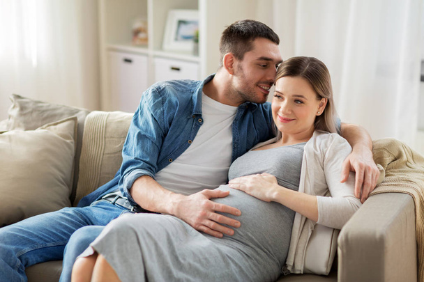 man hugging pregnant woman at home - Valokuva, kuva