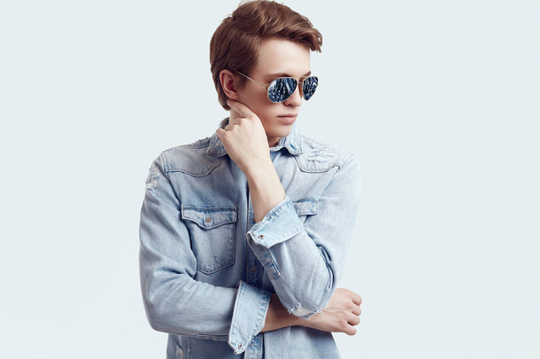 Beau hipster homme à la mode lunettes de soleil portant une veste en jean
 - Photo, image