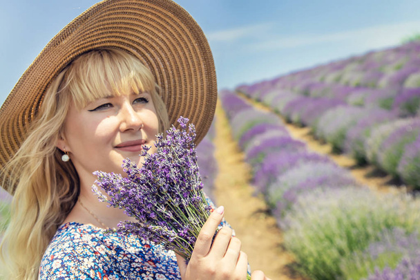 Girl in a flowering field of lavender. Selective focus. - Фото, зображення