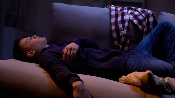 Exhausted teenage student sleeping at home in evening, hanging out with friends - Fotoğraf, Görsel