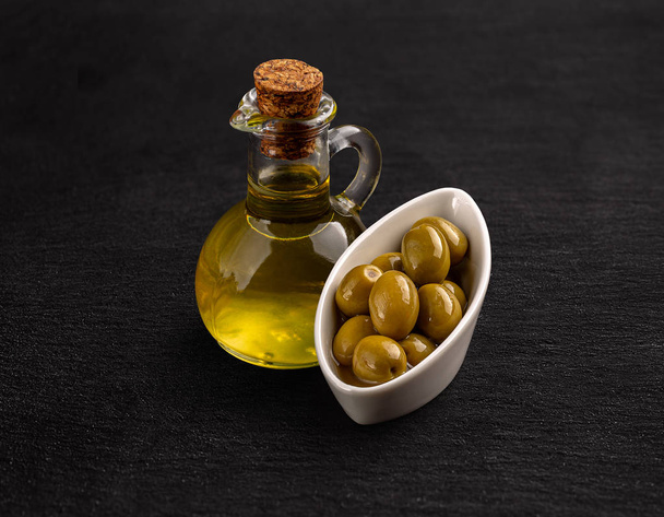 Olive oil and green olive seeds  - Photo, Image