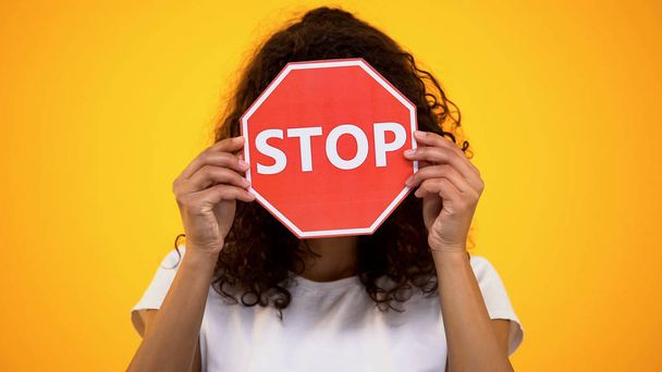 Young woman showing stop sign, protesting against racism and violence, awareness - Fotografie, Obrázek