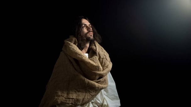 Biblical prophet in robe looking at light, belief spirituality and religion - Valokuva, kuva