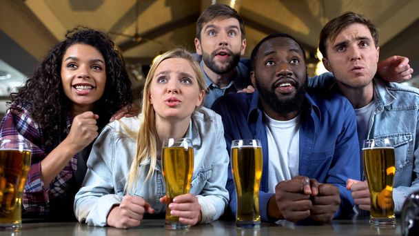 Group of multiethnic friends worrying about favorite team, watching championship - Fotó, kép