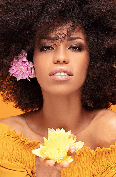 Beauty afro woman with fresh flowers. - Zdjęcie, obraz