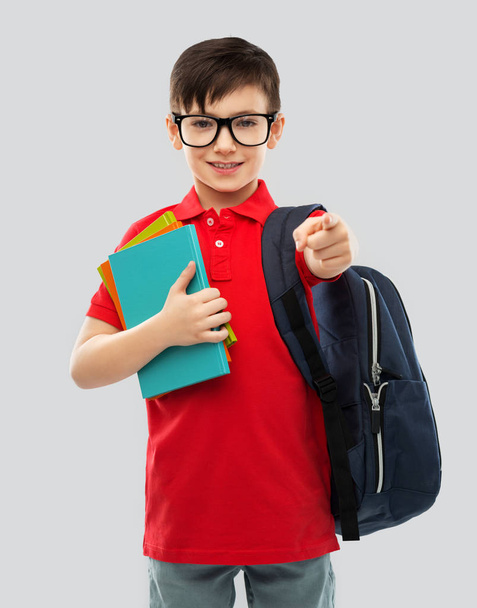smiling schoolboy in glasses with books and bag - Fotoğraf, Görsel