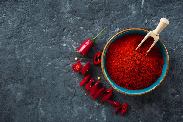 Chili pepper powder on dark background with copy space top view - Фото, изображение