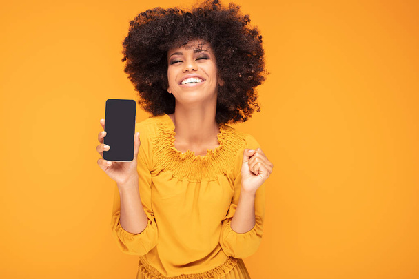 Excited afro girl with mobile phone. - Foto, Imagen