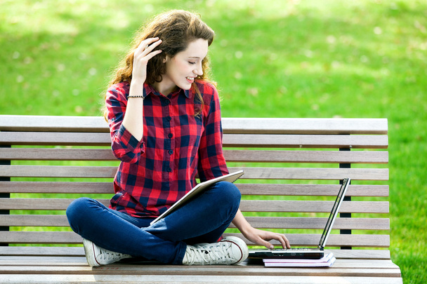 Chica haciendo su tarea al aire libre
 - Foto, imagen