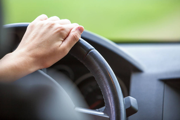 Woman hands on steering wheel driving a car. - Photo, image