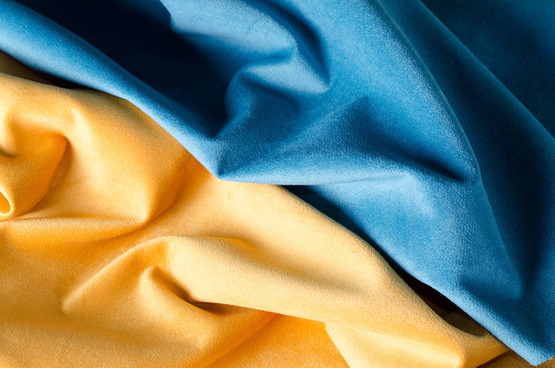 Yellow and blue soft velour fabric. Colors of ukrainian flag. Fabric texture background. - Foto, afbeelding