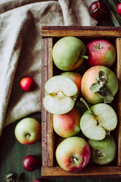 Homemade ripe garden apples in a wooden box - Photo, Image