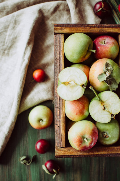 Homemade ripe garden apples in a wooden box - Photo, Image