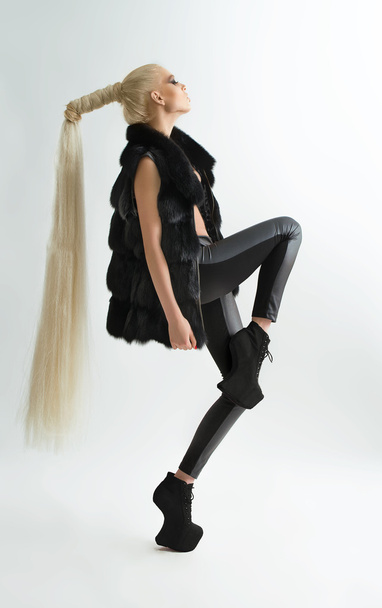 Fashion shot of a trendy girl with long hair - Fotografie, Obrázek