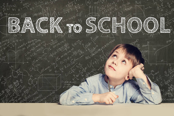 Back to school text and happy kid on chalkboard background - Foto, imagen