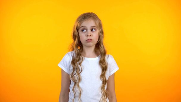 Cute confused preteen girl looking aside feeling uncertain lack of ideas, choice - Photo, image