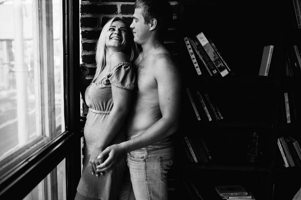 black and white photo of young couple in love posing in appartment  - Foto, Imagen