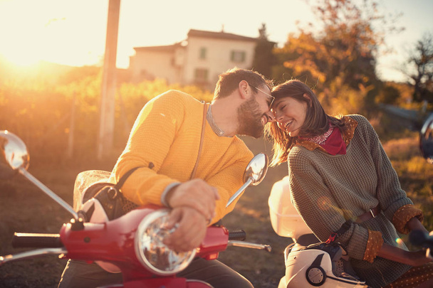 Romantic couple riding on a scooter and enjoying on journey - Valokuva, kuva