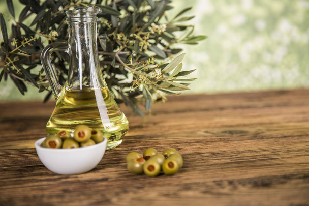 Olive oil, olive tree and green olives, bottles of olive oil - Fotoğraf, Görsel