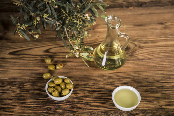 Olive oil, olive tree and green olives, bottles of olive oil - Photo, Image