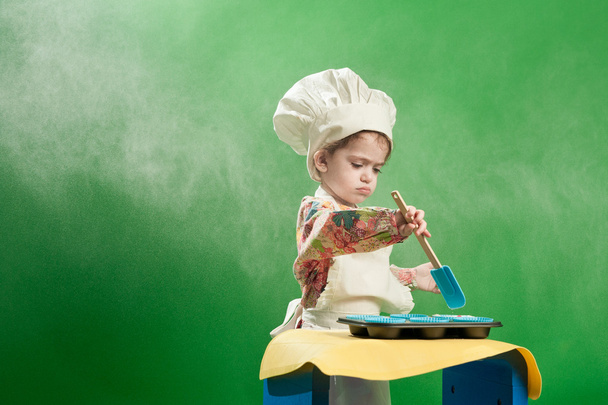 Small girl cooking in chef's hat and apron - Foto, imagen