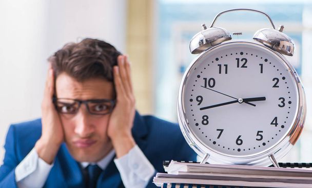 Businessman with giant clock failing to meet deadlines and missi - Photo, image