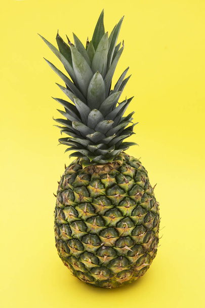 tropical summer fruit, pineapple on yellow background - 写真・画像