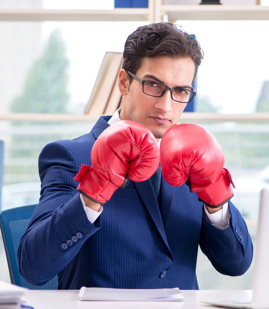 Επιχειρηματίας με γάντια πυγμαχίας θυμωμένος στο γραφείο - Φωτογραφία, εικόνα