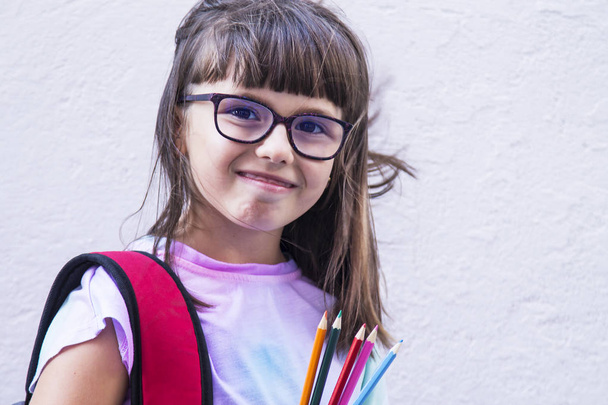 student with backpack and colored pencils going to school - Photo, Image