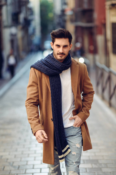 Young man wearing winter clothes in the street. - Fotoğraf, Görsel