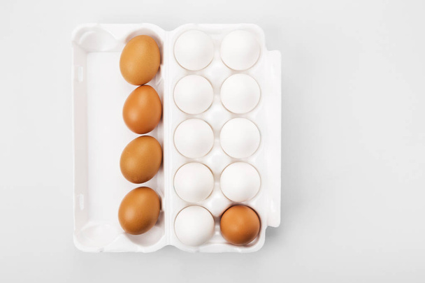 Group of raw eggs white and brown. Concept of diversity, isolati - Zdjęcie, obraz