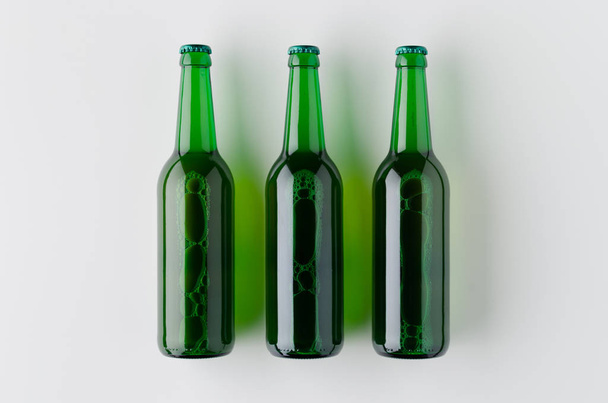 Top view of three beer bottles mockup. - Fotografie, Obrázek