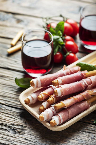 Italian antipasto with brad sticks and pork ham - Photo, Image