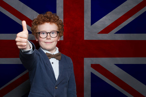 Happy young boy student on the UK flag background. Learn English - Photo, Image