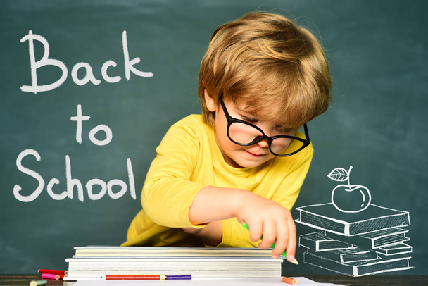 Talented child. Blackboard background. First school day. Kids school. Hard exam. Cheerful smiling child at the blackboard. - Fotó, kép