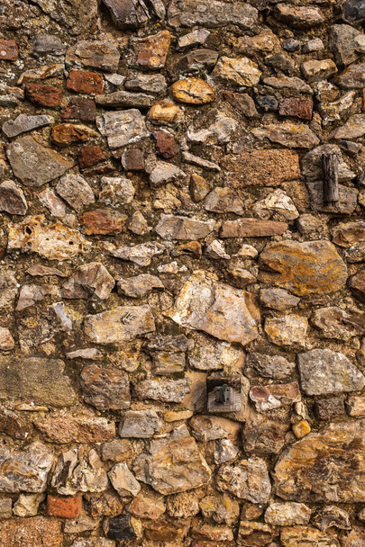 Una pared hecha de grandes rocas y cemento, ideal para un fondo o fondo de pantalla
 - Foto, Imagen