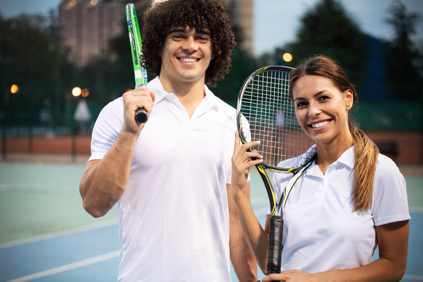Group of fit friends at the club playing tennis - Photo, image