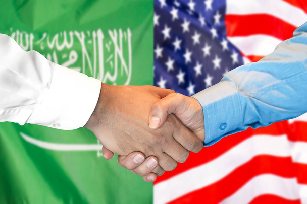 podání ruky na pozadí vlajky Saúdské Arábie a USA. - Fotografie, Obrázek