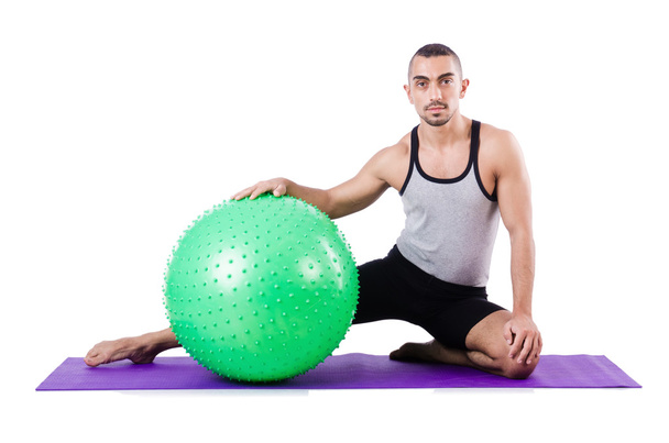 Man with swiss ball doing exercises on white - Photo, image