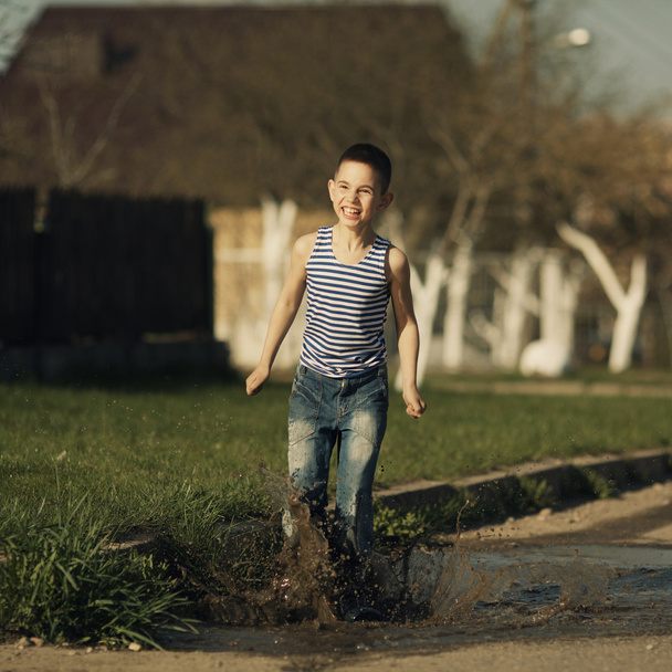 little boy standing in puddle - Fotó, kép